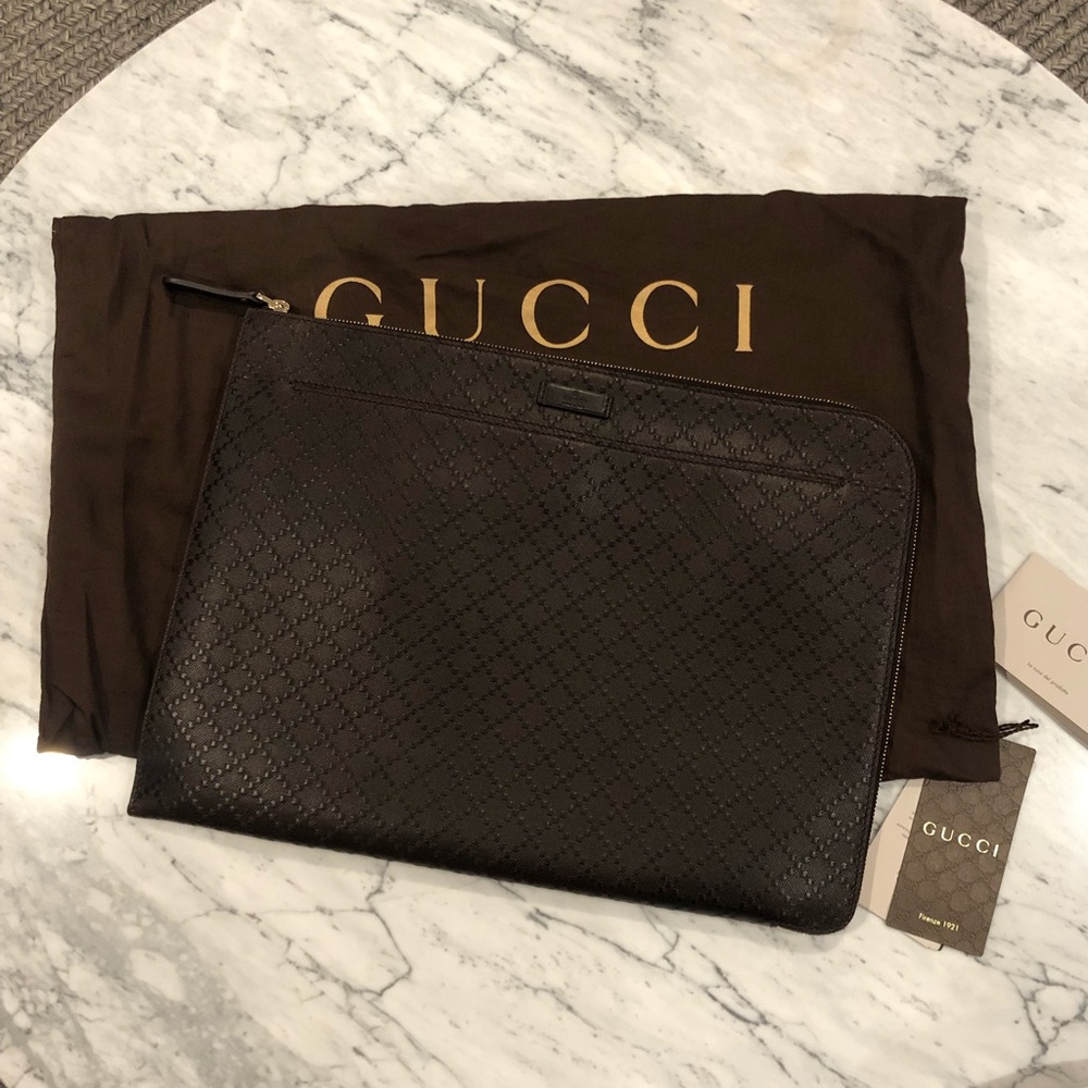 Brown leather Gucci portfolio.